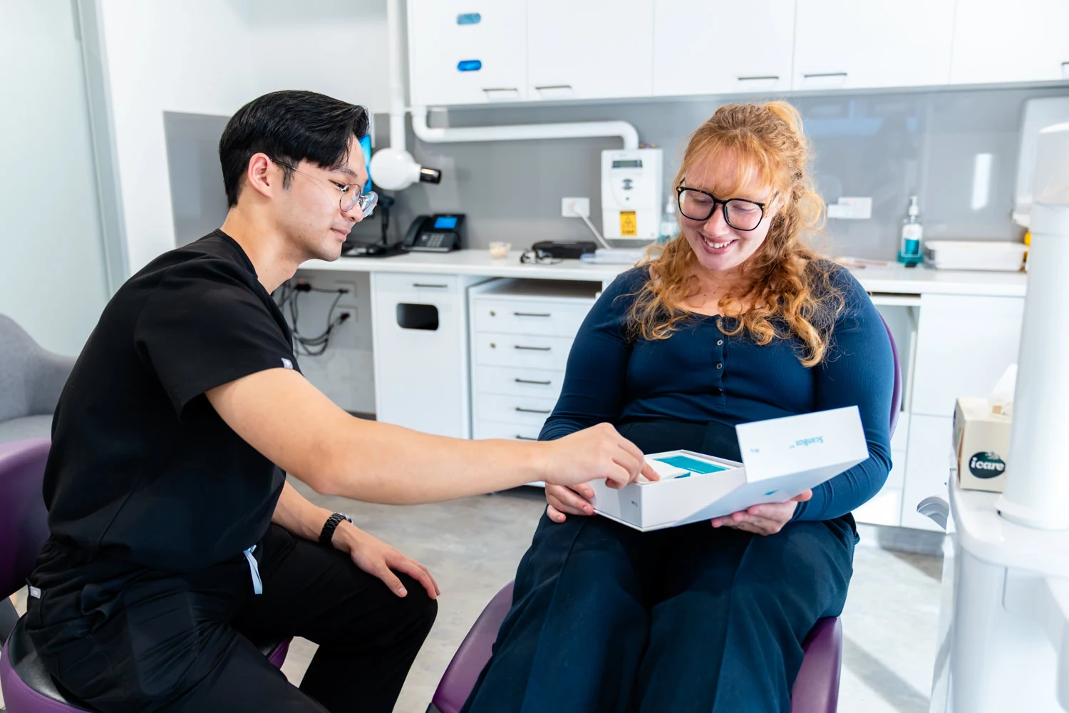 Dental Consultation with patient with teeth model