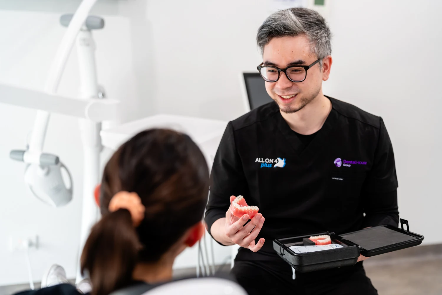 Female dentist showing the invisalign to the patient